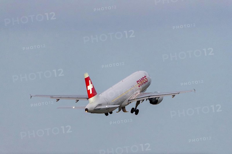 A Swiss aeroplane takes off into the sky with a clear blue background, Stuttgart