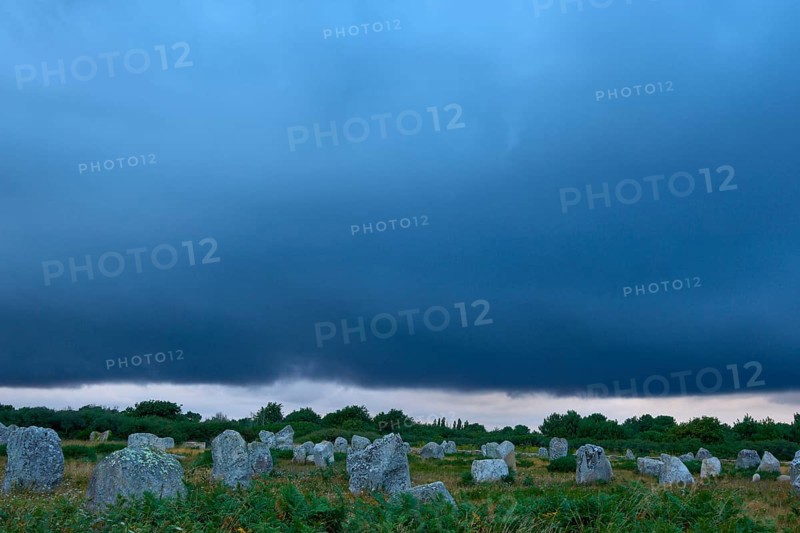 Neolithic menhirs, standing stones in Carnac with dramatic stormy sky, Carnac, Quiberon, Morbihan, Brittany, France, Europe