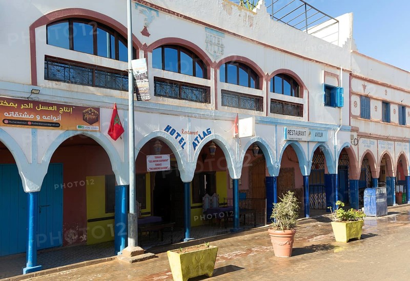 Historic buildings shops and hotel in arcaded shopping street in town centre, Mirleft, southern Morocco, North Africa