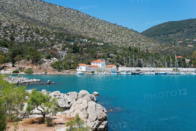 Harbour with boats in front of a picturesque mountainous landscape by the sea, harbour of Methana, spa in the background, peninsula Methana, Argolis, Saronic Islands, Peloponnese, Greece, Europe