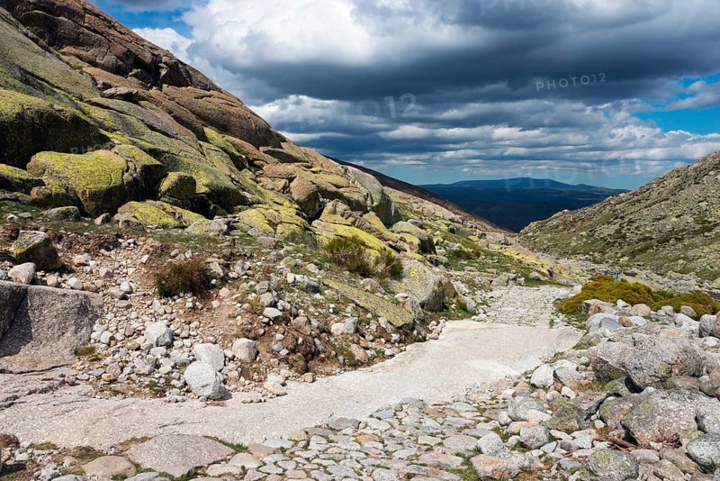 A stony path in a rocky mountain landscape under a cloudy sky, hiking area, Reserva national de Gredos, Garganta de Prado Puerte, Prado Puerte Gorge, Sierra de Gredos, Ávila, Avila, Madrid, Spain, Europe