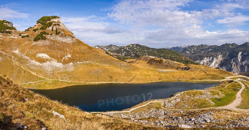 Panorama. Lake Augstsee and the Atterkogel mountain on the Loser. View of other mountains. Autumn, good weather, blue sky and clouds. Reflection. Altaussee, Bad Aussee, Ausseer Land, Totes Gebirge, Styria, Upper Austria, Austria, Europe
