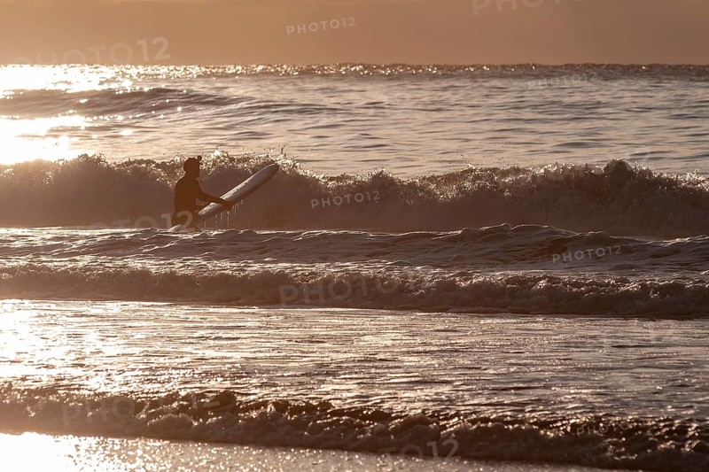 Surfer in the surf at Unnstad beach, winter surfing, Lofoten Island Vestvågøya Lofoten, Northern Norway, Norway, Europe