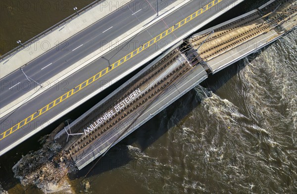Partial collapse of the Carola Bridge, on the debris still lying in the Elbe, activists have affixed the lettering Tax millionaires, Carola Bridge in Dresden, Dresden, Saxony, Germany, Europe