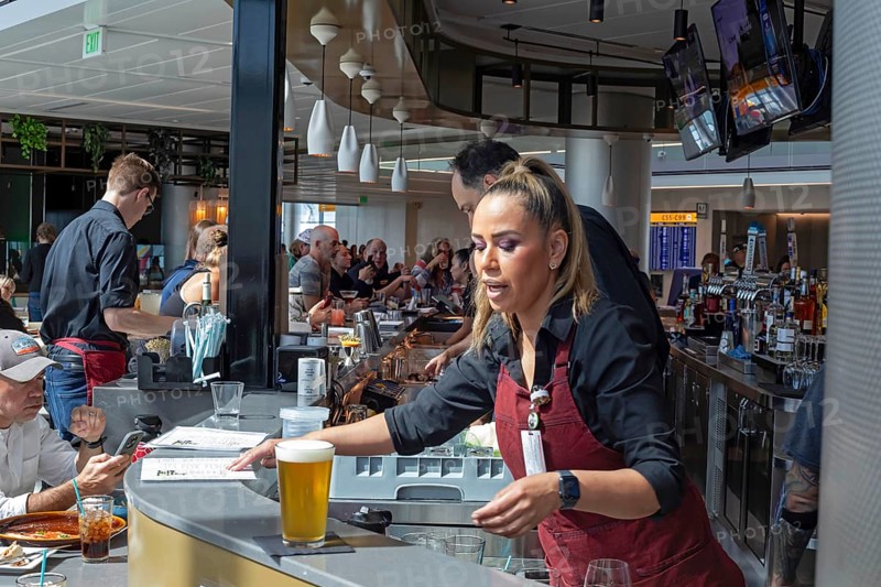 Denver, Colorado, Workers at bar dough, an airport restaurant and bar, serve travelers at Denver International Airport