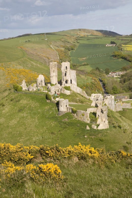 Corfe Castle is located in a natural defensive site on a hill between chalk ridges and for a thousand years has guarded the entry into the Isle of Purbeck. The ruined state of the castle date from the English Civil War when it was twice held siege in the 1640s and subsequently largely demolished