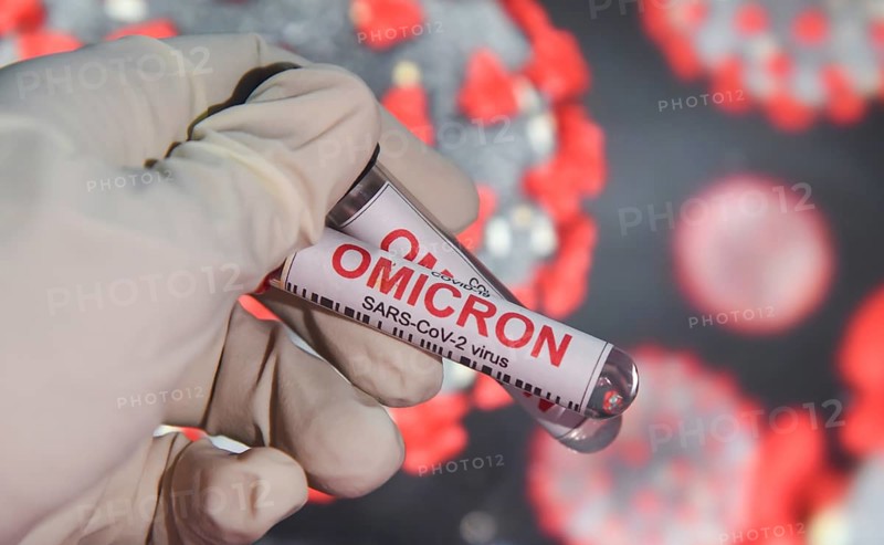 In this photo illustration, a person wearing gloves holding test sample tubes labeled 'COVID-19 Omicron variant' in front of a display, on December 22, 2021 in Guwahati, India. More than 150 confirmed cases of the Omicron variant have been detected in India