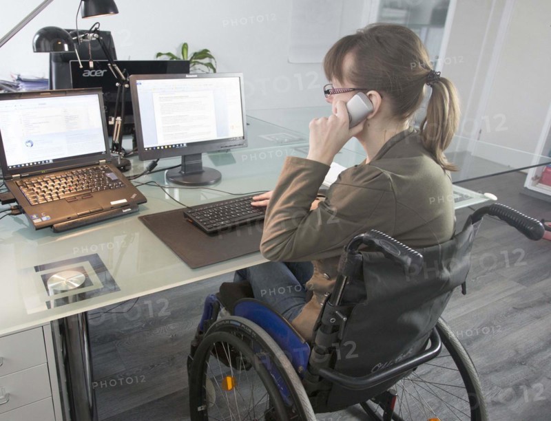 Young woman in a wheelchair at her workplace, Berlin, 18/01/2017