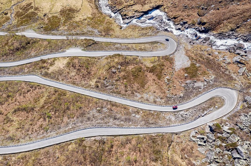 Aerial view of mountain pass road over the Vikafjell, between Hardanger and the Sognefjord, serpentines of a winding road, early summer, Norway, Europe