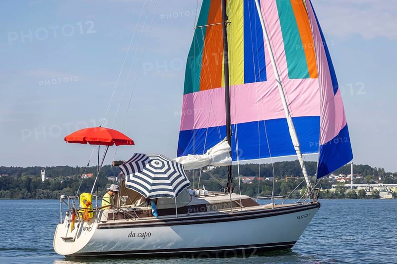 Sailing party on Lake Constance, yacht with colourful foresail and sunshades, Immenstaad, Baden-Württemberg, Germany, Europe