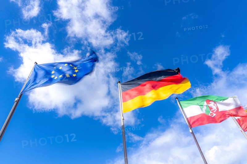 Waving flag of the European Union, Germany flag, state flag of North Rhine-Westphalia