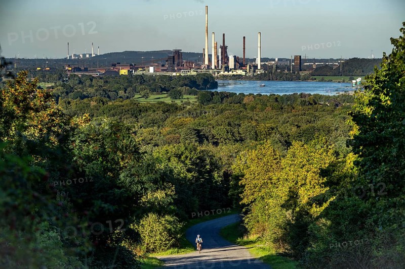 View, from the Rheinpreußen spoil tip in Mörs, across the Rhine to the Thyssenkrupp Steel steelworks in Duisburg-Beeckerwerth, blast furnaces, coking plant, green landscape on the left bank of the Rhine, North Rhine-Westphalia, Germany, Europe