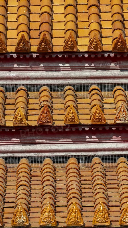 Roof decoration on the Uposatha Hall, Ubosot, the roof is staggered in three tiers and covered with rows of golden yellow glazed Chinese tiles, the last tile of each row at the eaves represents a heavenly angel offering the traditional Thai obeisance Wai to the viewer with folded hands, Wat Benchamabophit, marble temple, Bangkok, Thailand, Asia