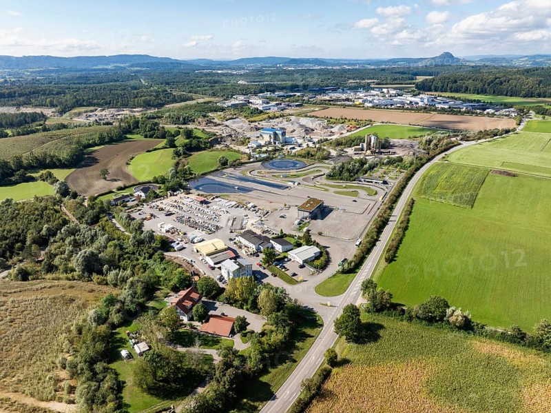Aerial view of a gravel pit, gravel extraction area, gravel works, ADAC driving safety centre, sewage treatment plant, asphalt mixing plant and building materials warehouse, in the Steißlingen Hegau industrial estate and business park, district of Constance