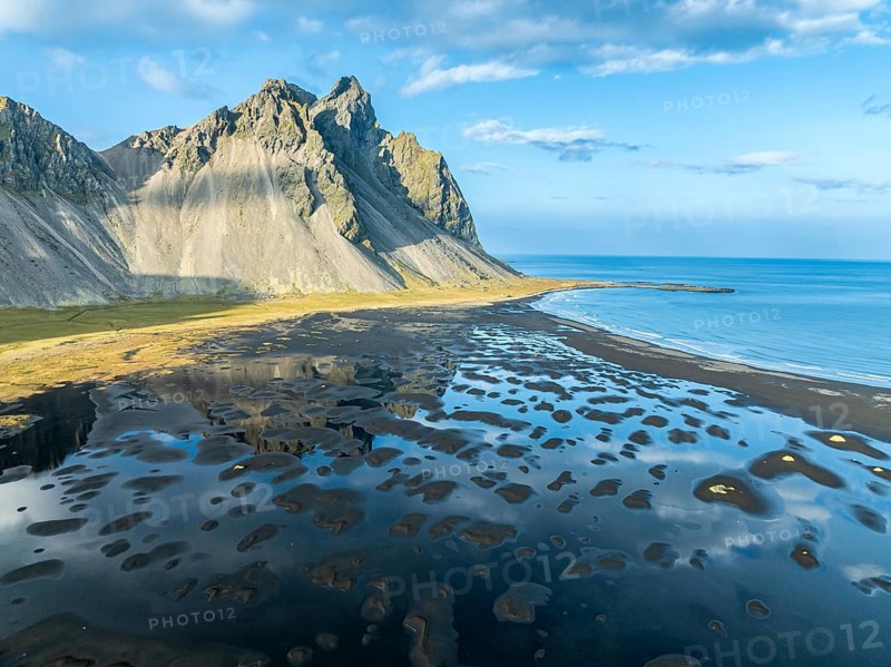 Aerial view of Mt. Vestrahorn, black lava beach, reflections on the water, Stokksnes, east of Höfn, East Fjords, Iceland, Europe
