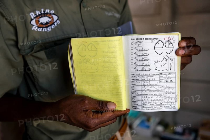 A ranger of the Rhino Rangers shows the data sheet of a rhino sighting, black rhino (Diceros bicornis), Huab Conservancy, near Khorixas, Kunene Region, Namibia, Africa