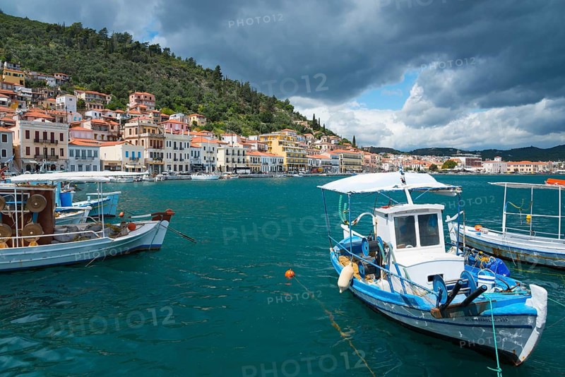 Harbour town with boats in the foreground and a forested range of hills in the background under a cloudy sky, Harbour, Gythio, Mani, Laconia, Peloponnese, Greece, Githio, Gythion, Europe