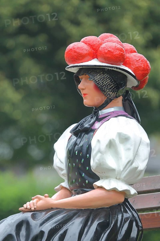 Doll in woman's traditional costume with Bollenhut on bench, Black Forest, Bollenhut, clothing, skirt, tradition, traditional, sitting, sculpture, flower decoration, Gutach-Black Forest railway, Ortenau, Southern Black Forest, Black Forest, Baden-Württemberg, Germany, Europe