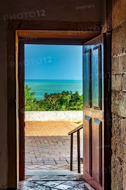 Old wooden door open inside the church overlooking the sea in the city of Olinda in Pernambuco, Olinda, Pernambuco, Brazil, South America