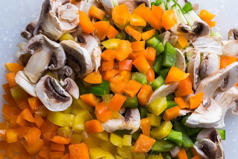 Close-up of diced green, orange and yellow bell peppers, sliced white mushrooms, Studio Composition, Quebec, Canada, North America