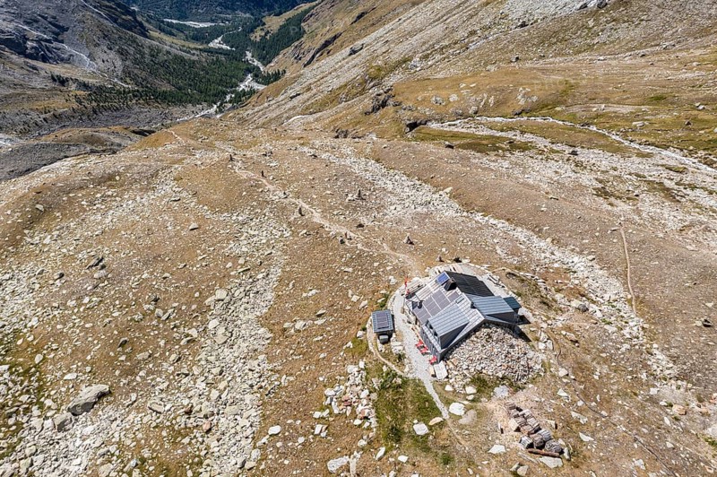 Aerial view of Cabane Arpitettaz in a rocky landscape close to a glacier, Zinal valley, Valais, Switzerland, Europe