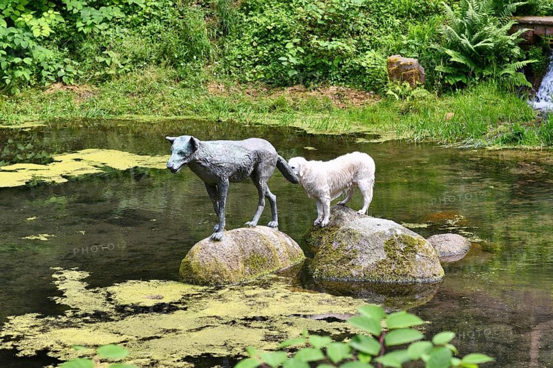 Heidelberg, Germany, June 8th 2024: Funny dog imitating wolf sculpture at historic well called 'Wolfsbrunnen' in Heidelberg-Schlierbach, Europe