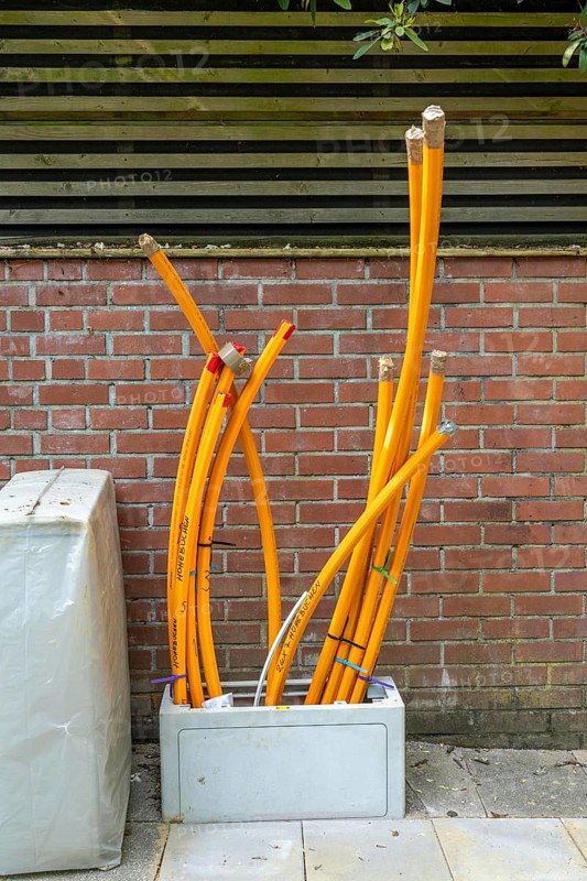 Distribution box in which empty conduits for fibre optic cables arrive and are connected, in which the actual fibre optic cable is later blown in and connected to the respective house connection. Essen, North Rhine-Westphalia, Germany, Europe