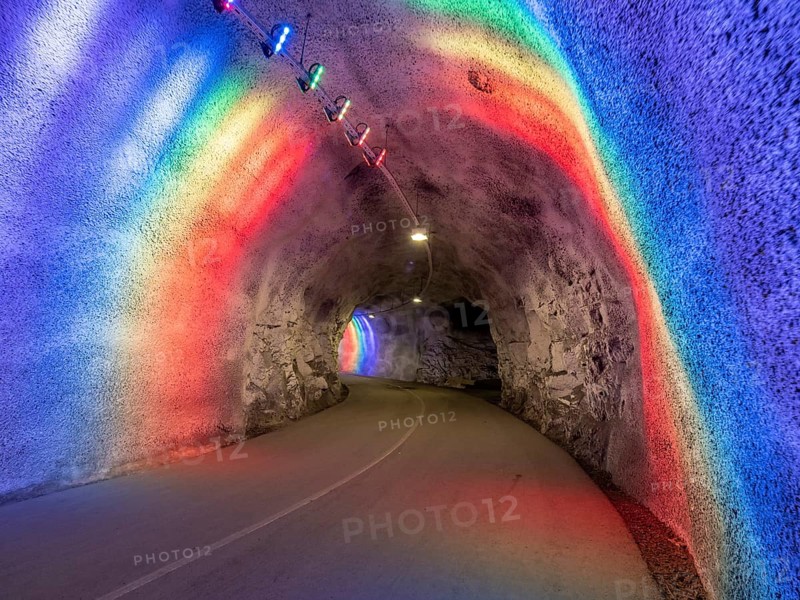 Colorful illuminated tunnel for bicycles and pedestrians leads up to Hardanger suspension bridge, Hardanger, Norway, Europe