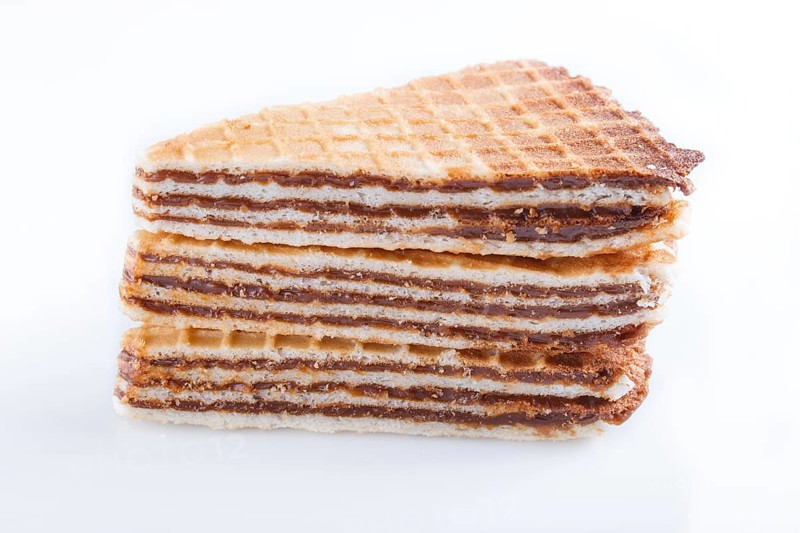 Waffle sandwiches with boiled condensed milk isolated on white background. closeup