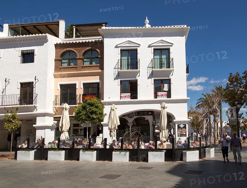 People sitting outside cafe at popular holiday resort town of Nerja, Malaga province, Spain, Europe