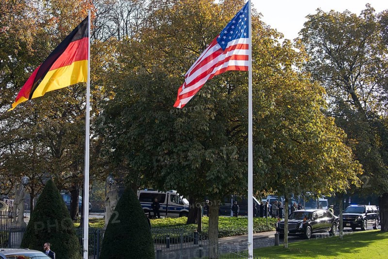 Joe Biden (46th President of the United States) drives past the flags of Germany, the USA and the EU in the presidential vehicle The Beast to Bellevue Palace, Berlin, 18 October 2024