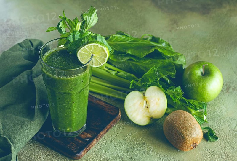 Glass, with green smoothie, celery and spinach, apple and kiwi, cucumber, with ingredients on the table, vegetable smoothie, breakfast, homemade, no people