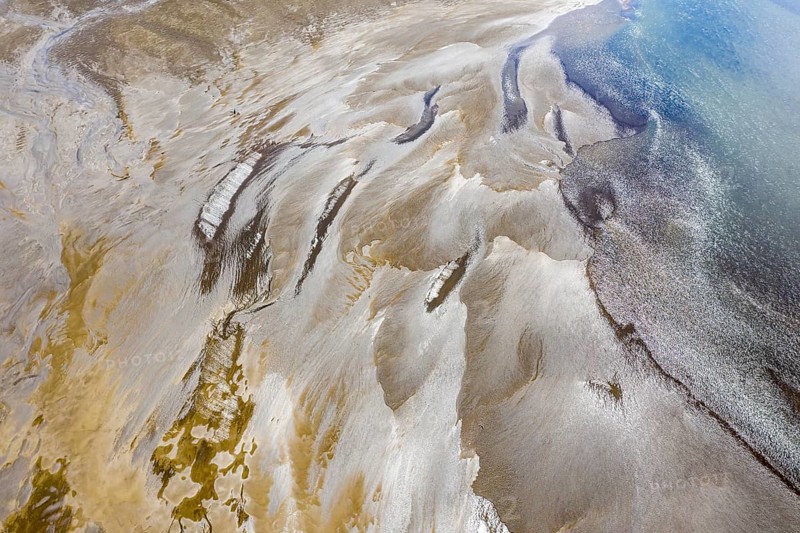Sandbank in the river Rio Ibanez short before flowing into lake Lago General Carrera, structures against the light, Patagonia, Chile, South America
