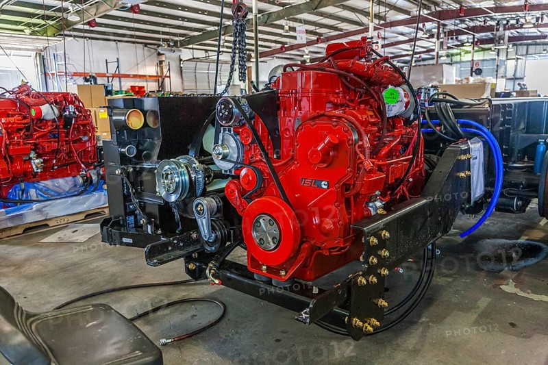 Cumins ISL diesel engines being installed onto chassis at Tiffin Motorhomes factory in Red Bay, Alabama, USA, North America