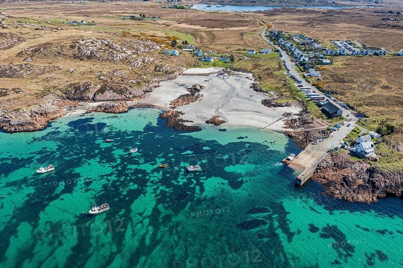Aerial view, top down view on turquiose water at the beach of Fionnphort, boat traffic to Iona island, Scotland, UK