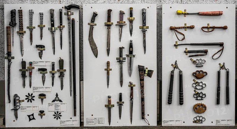 Prohibited weapons seized by the police, cutting and stabbing weapons, knives, machetes, switchblades, brass knuckles, batons, a representation of the police