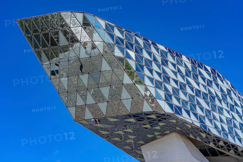 The Antwerp Port Authority building, Havenhuis, former fire brigade barracks in the harbour, renovated and with an attached glass structure in the shape of a ship's hull, administrative headquarters of the Antwerp Port Authority, designed by Zaha Hadid, Antwerp, Flanders, Belgium, Europe