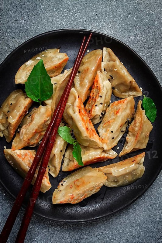 Japanese fried dumplings, gyoza, sesame seeds, top view, no people