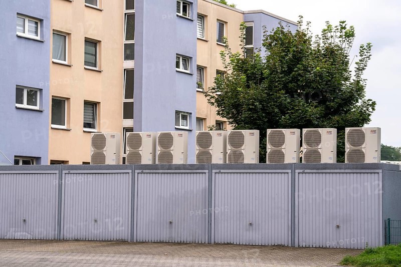 Heat pumps in a residential area, multi-family houses are supplied with heating, cooling and domestic hot water via these devices, installed on garage roofs, modernisation of the flats, Duisburg, North Rhine-Westphalia, Germany, Europe