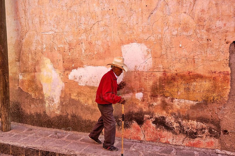San Miguel de Allende, Mexico-3 December, 2018: Old man walking down the streets of San Miguel de Allende in historic city center
