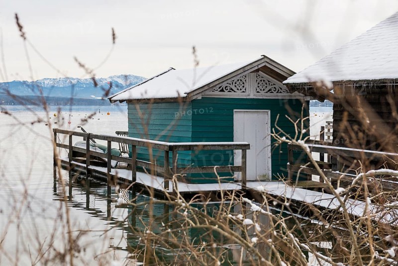 Boathouses with snow in winter, Tutzing, Lake Starnberg, Fünfseenland, Pfaffenwinkel, Upper Bavaria, Bavaria, Germany, Europe