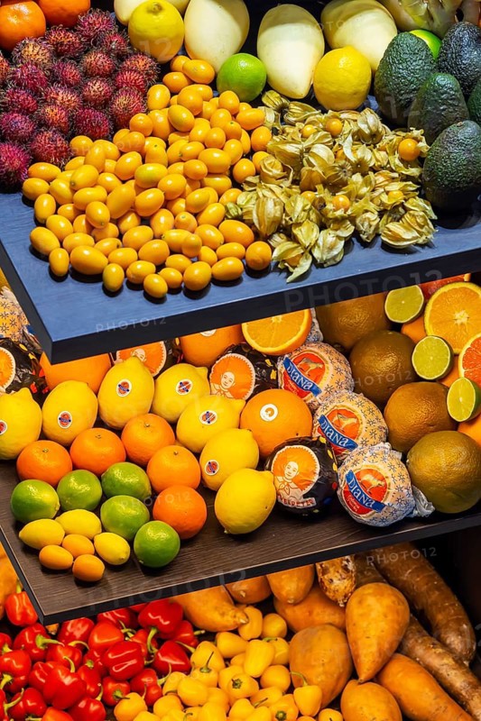 Exotic fruits, lychee, jackfruit, dragon fruit, mango and citrus fruits presented on a table, Germany, Europe