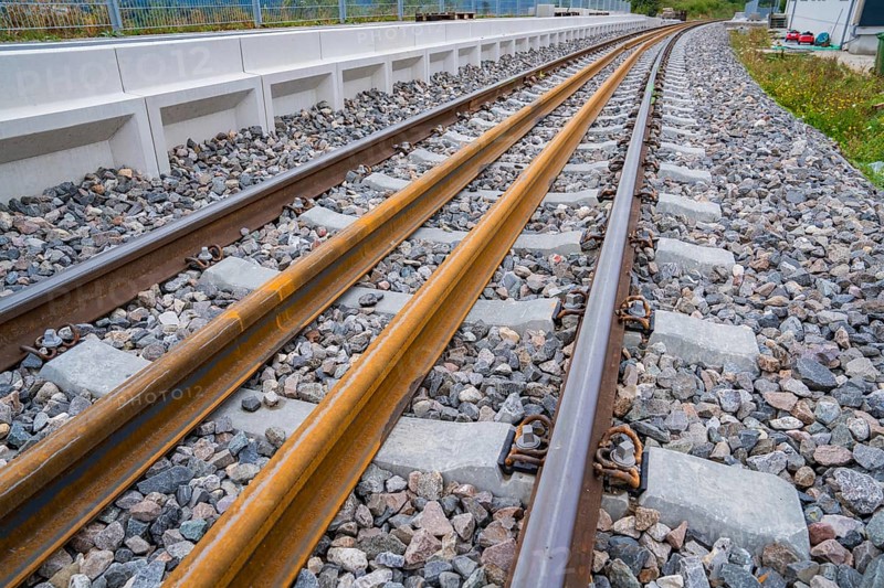 Close-up of rails in a curve, enclosed by rocky ballast and a railing, track construction, rail delivery for Hermann Hessebahn, Calw, Black Forest, Germany, Europe