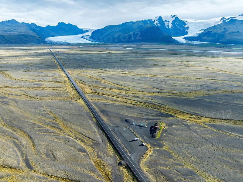 Aerial view of the Skeidara Bridge Monument viewpoint, large metal parts of the bridge that was destroyed by the 1996 glacier run, glacier Skaftafelljökull and Svinafellsjökull in the back, Iceland, Europe