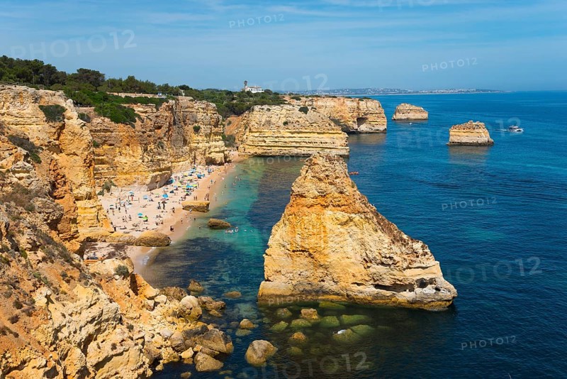 A beautiful beach on a rocky coast with clear blue water and sunny skies, Praia da Marinha, Lagoa, Rocky Algarve, Algarve, Portugal, Europe