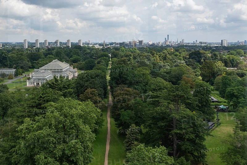 View from the large pagoda over a long path lined with trees and a greenhouse into the centre of London, Royal Botanic Gardens (Kew Gardens), UNESCO World Heritage Site, Kew, Greater London, England, United Kingdom, Europe
