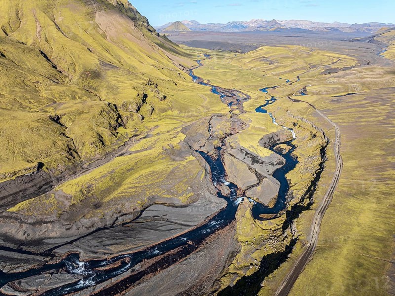 Road F232 Öldufellsleid, along northern slopes of glacier Myrdalsjökull and moss-covered Mt. Öldufell, Mt. Maelifell in the back, black lava sand, aerial view, Iceland, Europe