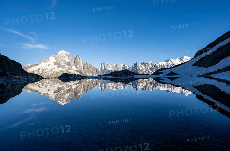 Mountaineer, silhouette in front of mountain landscape in the evening light, water reflection in Lac Blanc, mountain peak, Aiguille Verte, Grandes Jorasses, Aiguille du Moine, Mont Blanc, Mont Blanc massif, Chamonix-Mont-Blanc, Haute-Savoie, France, Europe