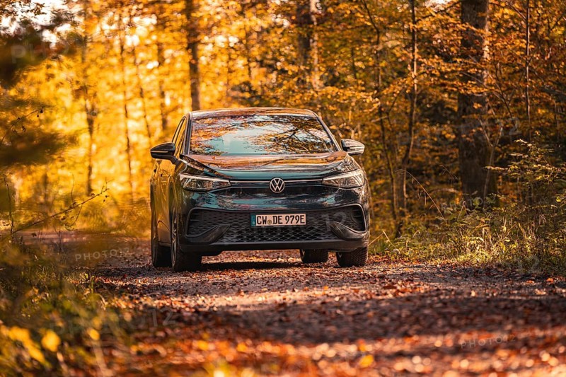 Vehicle on forest path in autumn with orange leaves, electric car VW ID5, Gechingen, Black Forest, Germany, Europe