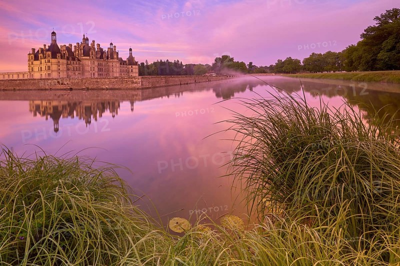 Chambord Castle with moat at sunrise, Chambord, Department Loir-et-Cher, Centre region, France, Europe